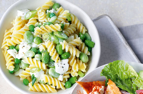 A fresh and creamy pasta salad that the whole family will enjoy: broadbeans, peas, mozzarella, and fusili with a spring onions, garlic, cream and lemon dressing. This dish has a certain springtime oomph and would also work well at a barbecue as a side.